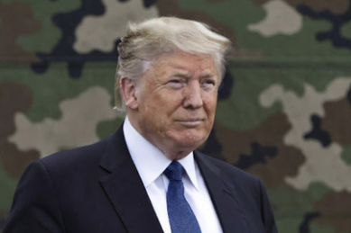 Donald Trump in front of camouflage background